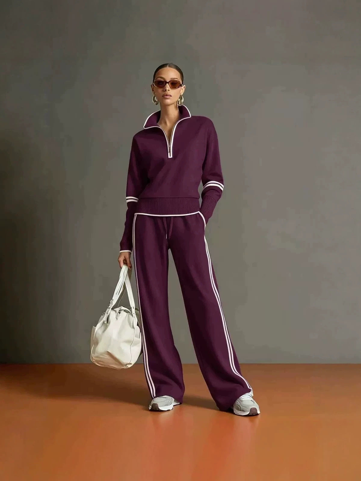 Purple half zip sweatshirt and wide leg pants set with white piping, worn full length