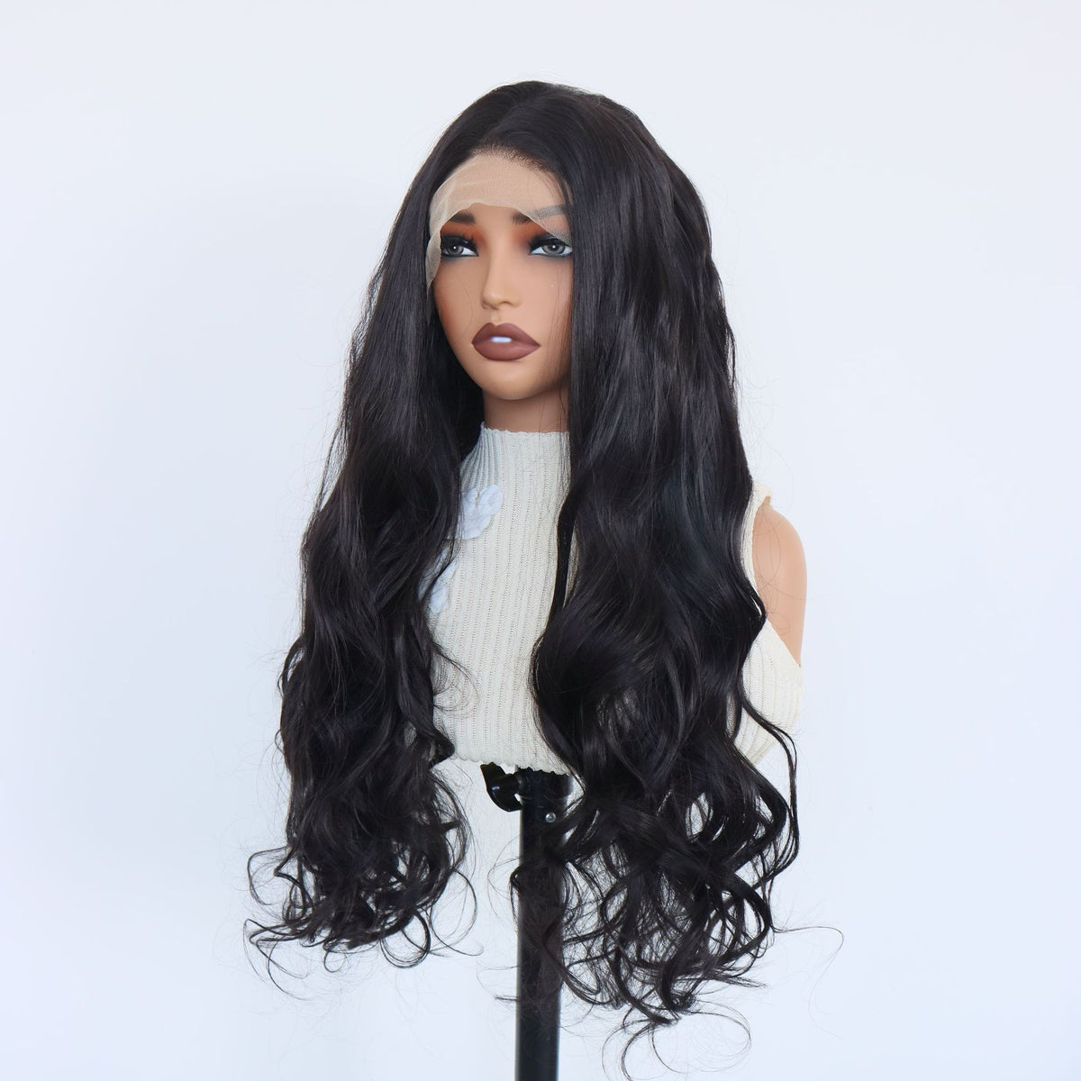 Front view of a long black wavy lace front wig falling in loose waves past the shoulders