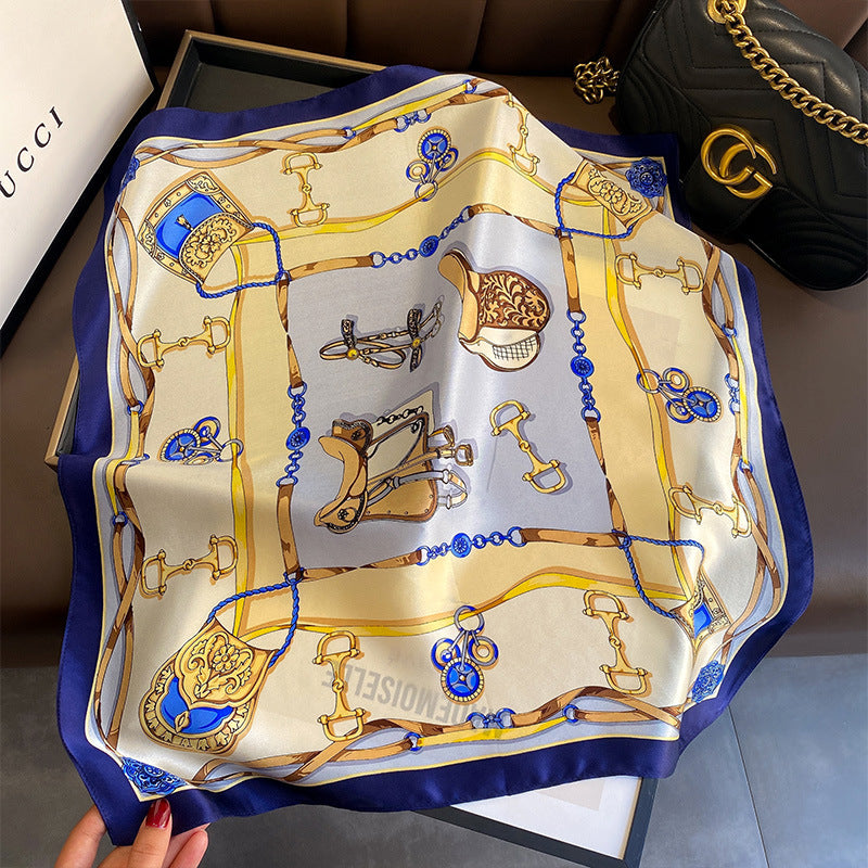 Cream and gold equestrian chain printed square scarf with a satin sheen and hemmed edges, shown displayed