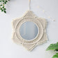 Styled set view of the woven wall mirror beside plants and decor
