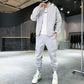 White tracksuit set jacket and joggers laid flat showing both pieces
