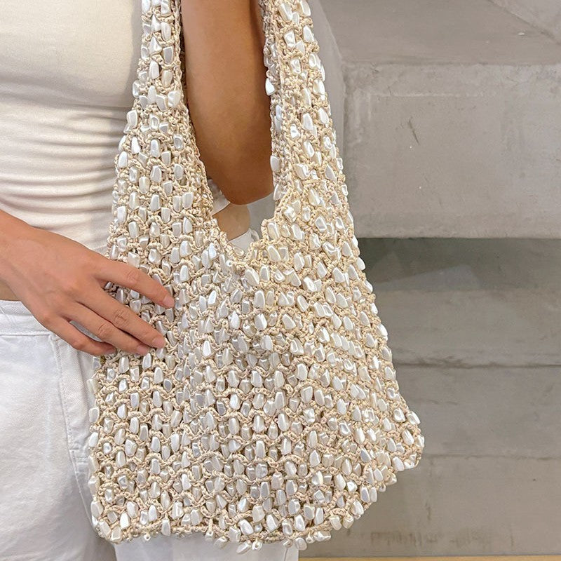 Side profile of the beaded crochet net bag showing the crocheted strap
