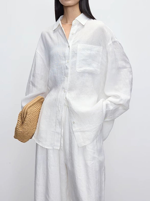 White relaxed linen shirt with lapel collar and chest pocket on a model