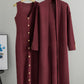 Wine red ribbed knit set, a sleeveless V neck button front dress and a long open cardigan on hangers
