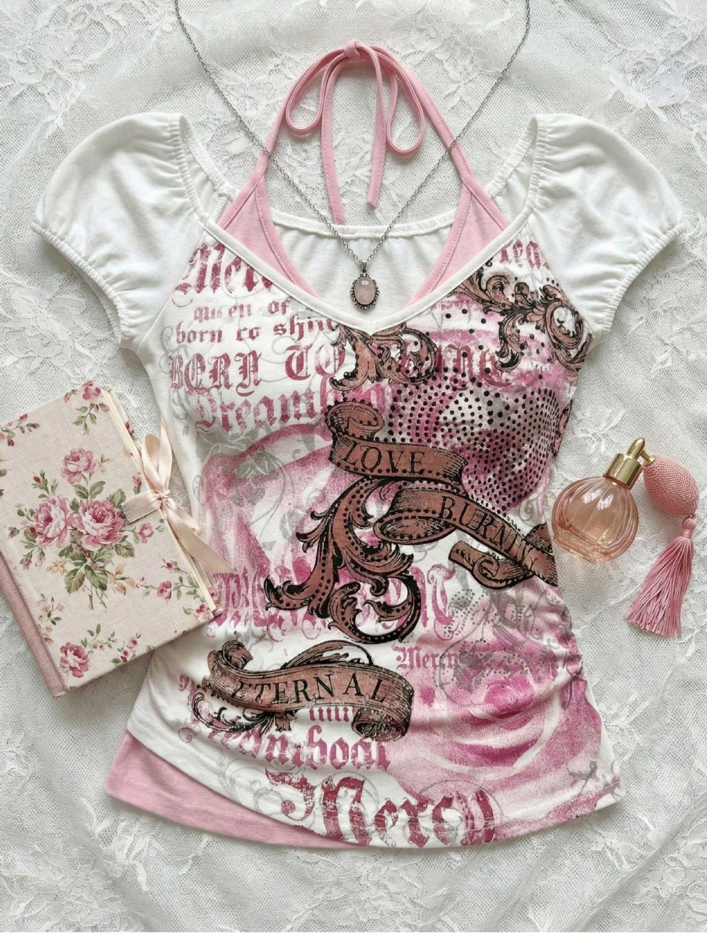 White printed halter tee shown with a rose card and perfume, pink neck ties visible