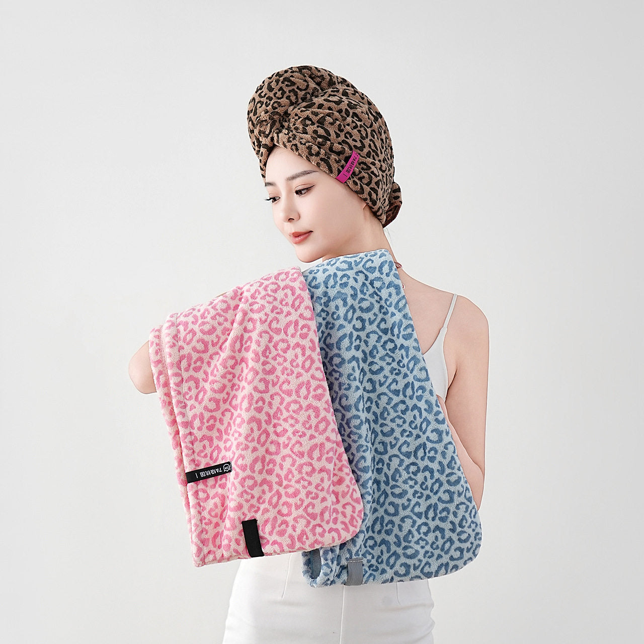 Side profile of the towel hair wrap showing the twist tail and sewn button closure