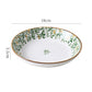 Green leaf porcelain soup spoon resting inside a matching bowl