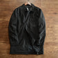Black mid-length quilted lined coat with lapel collar and button cuff tab on a hanger, size S option