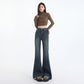 Detail of brass zip and metal button closure on the high waistband