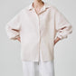 Light blue linen shirt draping loose over the body with long sleeves