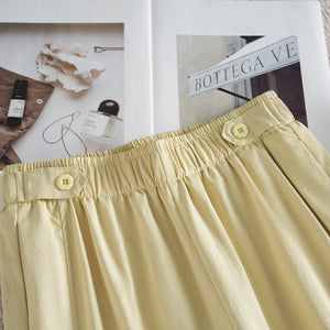 Lemon yellow wide leg pants waist detail with flower shaped button tab and elastic band