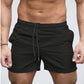 Black lightweight drawstring beach shorts front view on male model