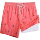 Coral men's swim trunks with navy anchor print and white drawstring