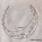 Close up of round rhinestones bezel set along the fine gold tone chain