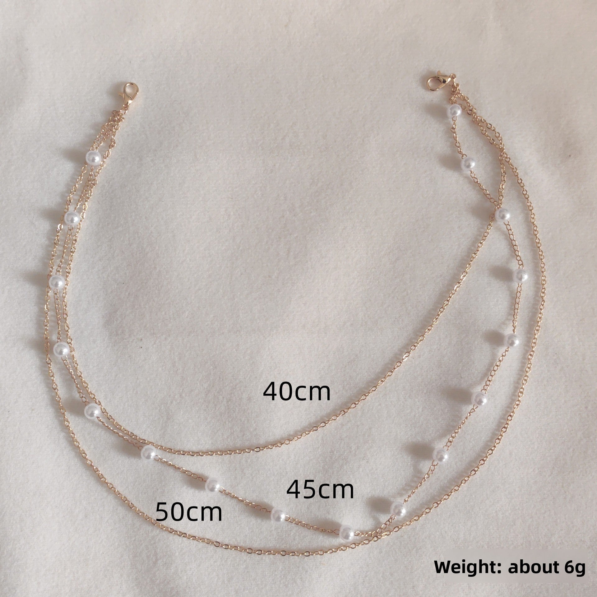 Close up of round rhinestones bezel set along the fine gold tone chain