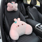 Pink rabbit headrest pillow with a teal bow and matching lumbar pillow on a black car seat