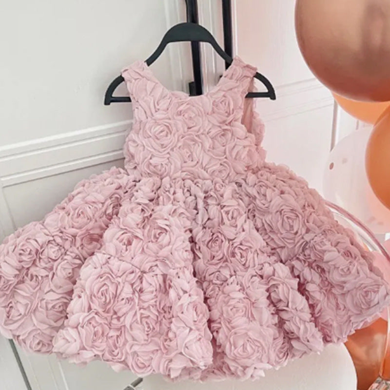 Pink rosette princess party dress folded to show the rose-covered skirt and lining