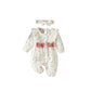 Baby floral romper held in hand to show its small newborn scale