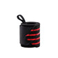 Black and red elastic wrist wrap rolled up on white, thumb loop standing clear