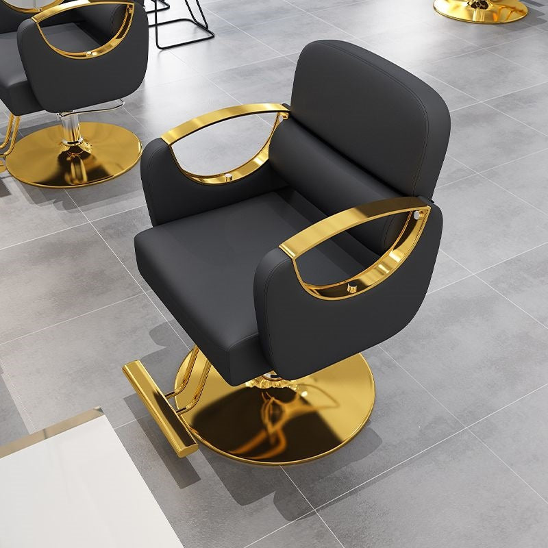 Black salon styling chair with silver metal armrests on a brushed silver square base