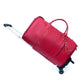 Red duffel travel bag with a tassel charm, a front zip pocket, two top handles and a pull rod