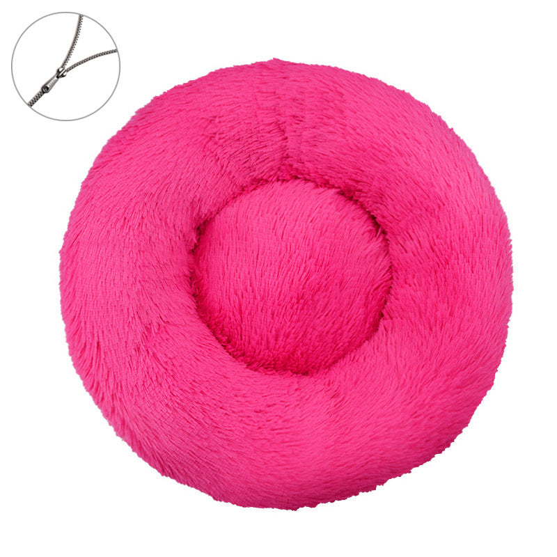 Rose red round plush pet bed with a raised bolster rim on a plain background