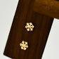 Side profile of one gold snowflake stud earring showing the post and butterfly back