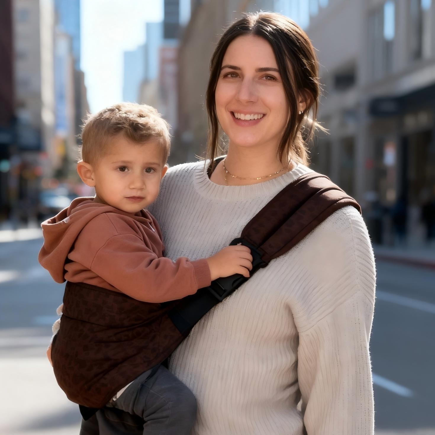 Front view of the leopard print one-shoulder baby sling with padded strap and buckle