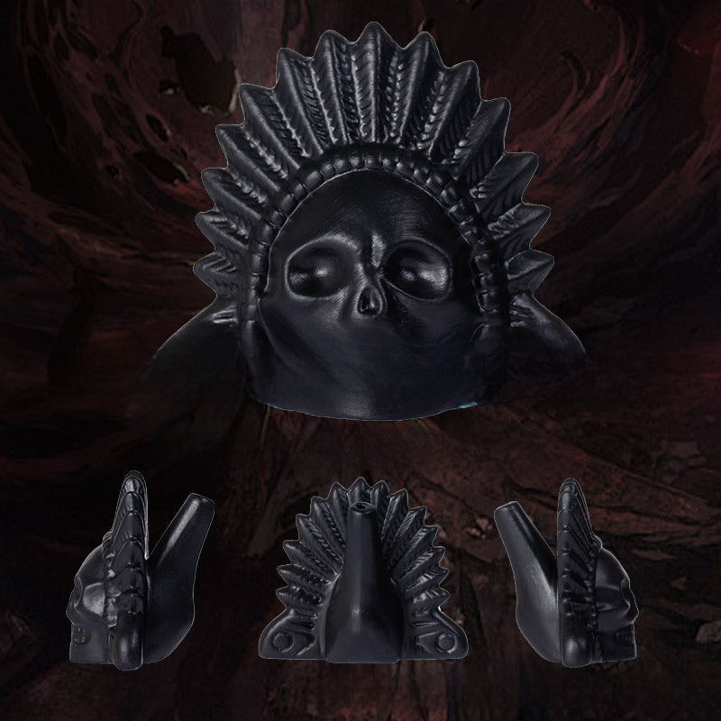 Matte black ceramic skull death whistle with carved feather headdress shown with front and side views
