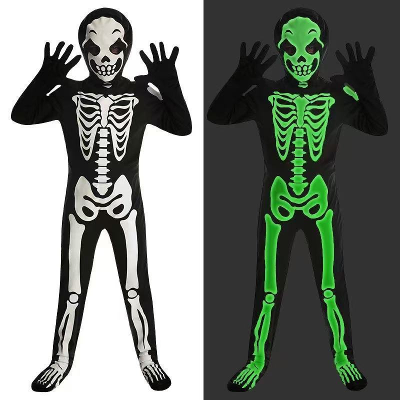 Black skeleton jumpsuit with white bone print, skull hood and gloves beside the same costume glowing green