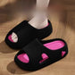Black EVA platform slide sandal worn on a foot over a wood floor