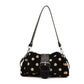 Black polka dot shoulder bag with cream dots and wide buckle band, shown for the Black option