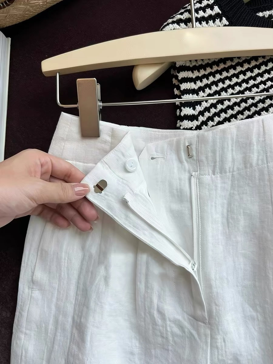 White linen shorts front zip fly open showing button and high waistband