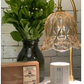 White candle warmer lamp with wood base on a desk