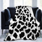 Person wrapped in the throw on the couch with a mug of tea