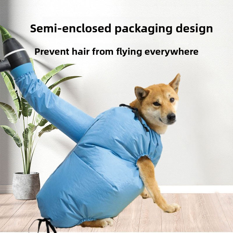Shiba dog sitting inside a blue semi enclosed pet drying bag with the head out and a hair dryer nozzle in the side port