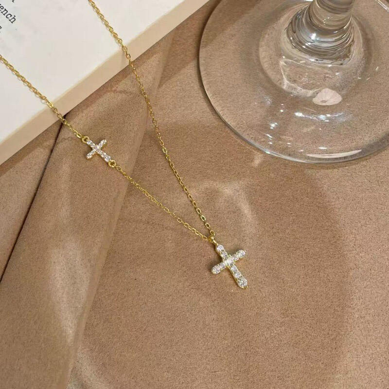 Gold tone double cross pendant necklace micro set with cubic zirconia, front view
