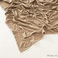 Corner of the modal cotton headscarf wrap showing the neat rolled hem and flat solid color