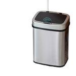 Brushed stainless steel sensor bin beside a low table, black lid with the sensor eye in the centre