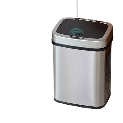 Brushed stainless steel sensor bin beside a low table, black lid with the sensor eye in the centre