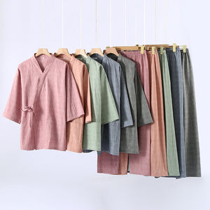 Row of kimono wrap pajama tops and trousers on hangers in several colors, some of them not offered in this listing