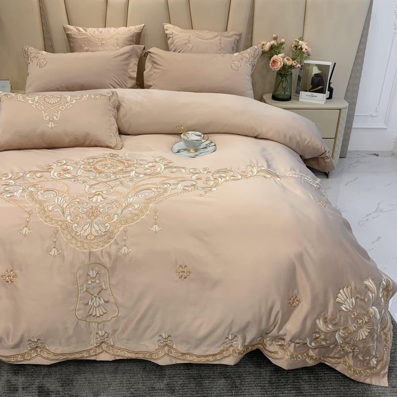 Bedside lamp glows across embroidered duvet face