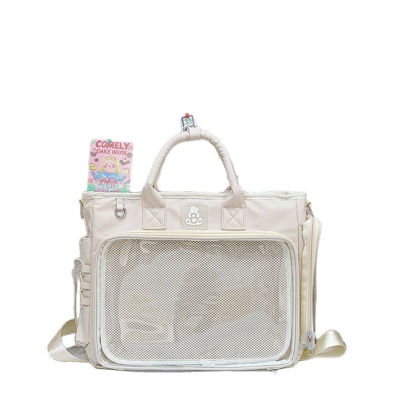 Lightweight nylon shoulder bag with a clear window pocket for pins and small charms