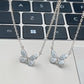 Blue butterfly pendant necklace worn at the neckline in daylight