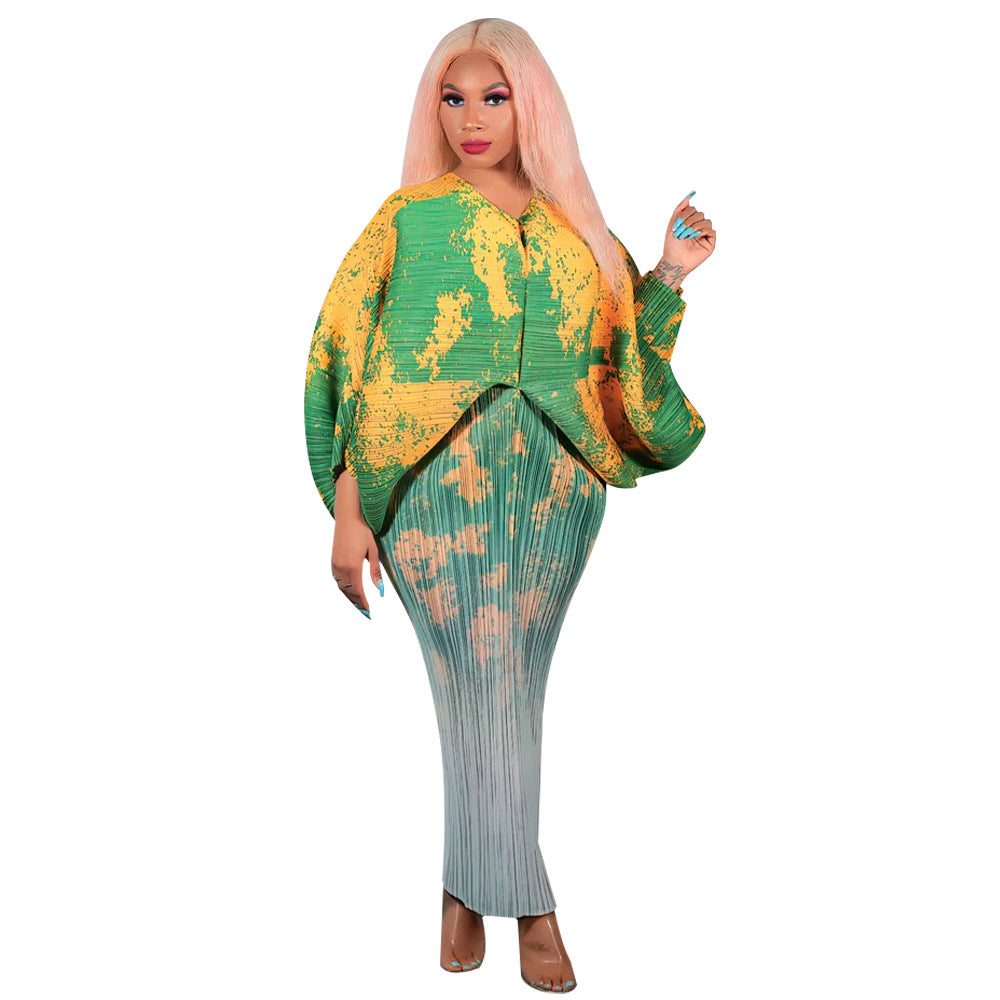 Abstract print pleated midi dress with batwing sleeves and V neck, styled with sandals