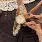 Beaded stone bracelet watch with a jewelry clasp and small gold tone case