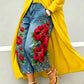 Wide leg cropped denim jeans with large red poppy flower print on blue denim, yellow open coat