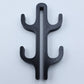 Black resin four hook with four arms, seen from the front on a light background