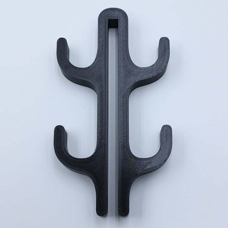 Black resin four hook with four arms, seen from the front on a light background