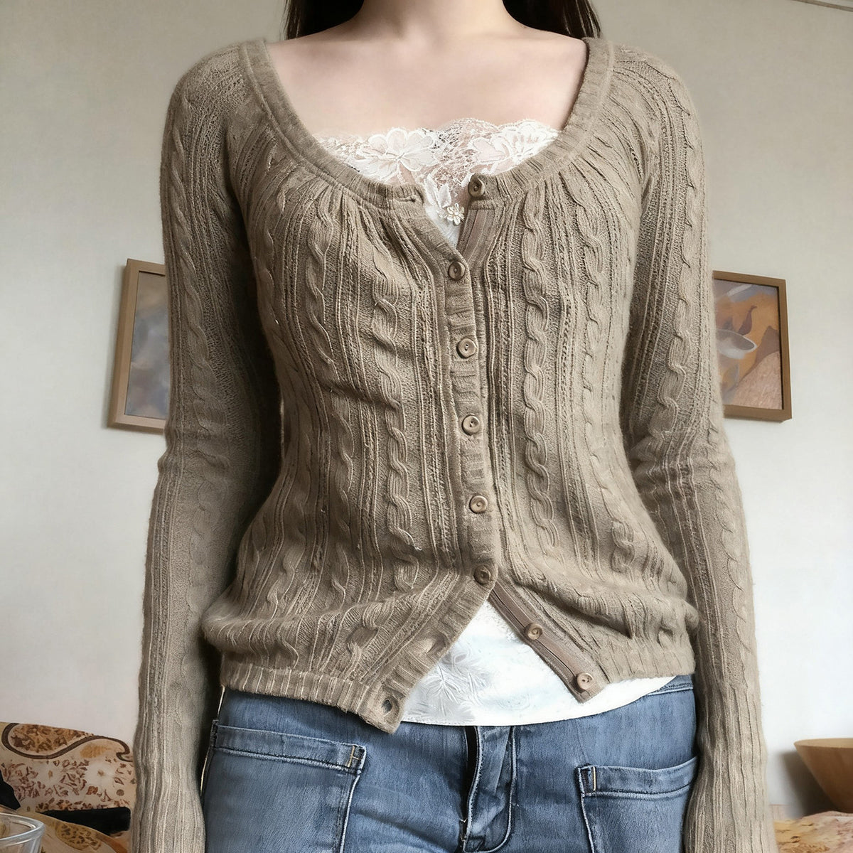 Khaki cable knit button cardigan worn open over a white camisole and jeans, full front view